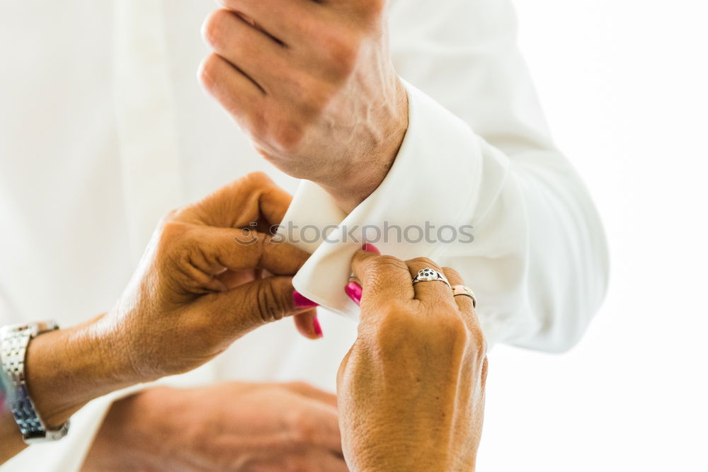 Similar – Image, Stock Photo A groom putting on cuff-links in his wedding day.