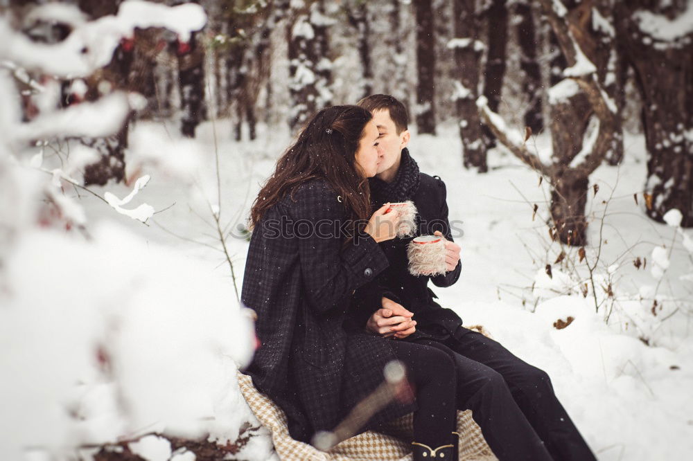 Couple having fun in winter forest