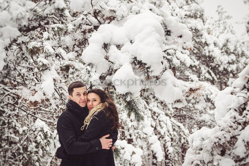 Image, Stock Photo romantic winter portrait of couple embracing in snowy forest