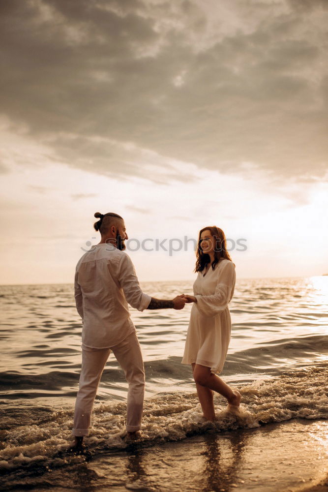 Similar – Image, Stock Photo Blonde woman and bearded man taking a walk embraced outdoors at sunset.