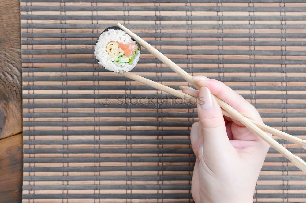 Similar – Crop woman eating sushi