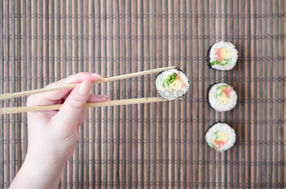 Similar – Crop woman eating sushi