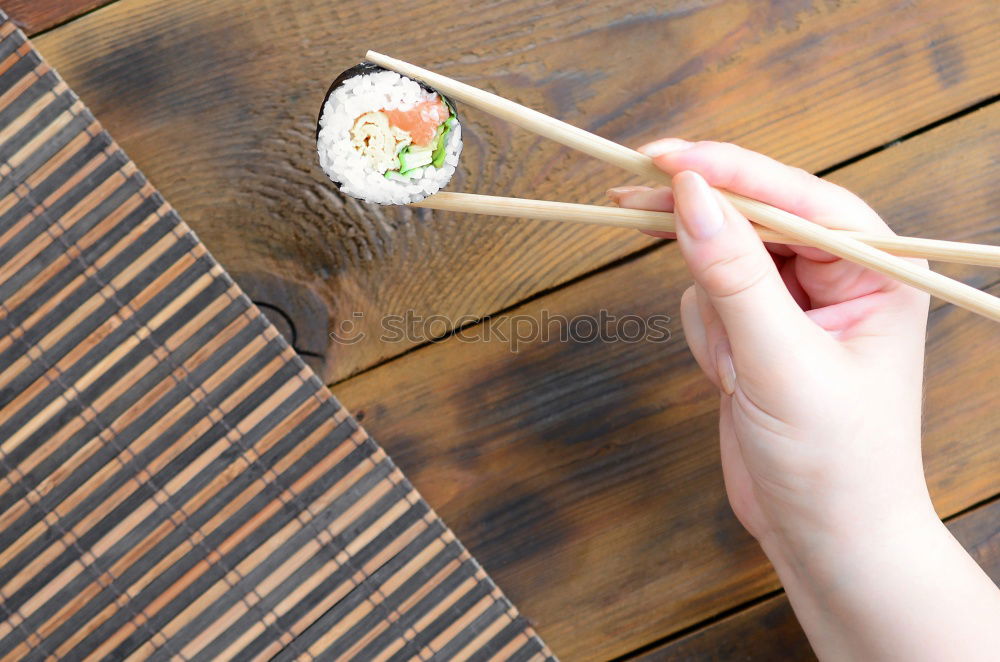 Similar – Woman chef hands rolling up japanese sushi