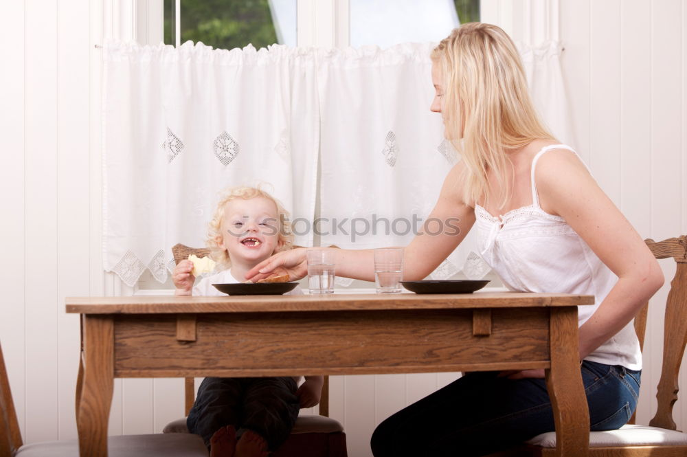 Similar – Image, Stock Photo A baby girl studies something on haunches, while her older brother watches her from upstairs sitting on the steps