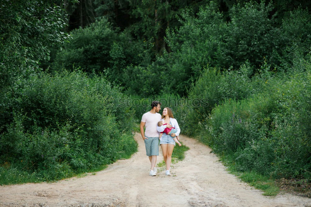 Similar – Retired couple walking their grandson on the path of a forest