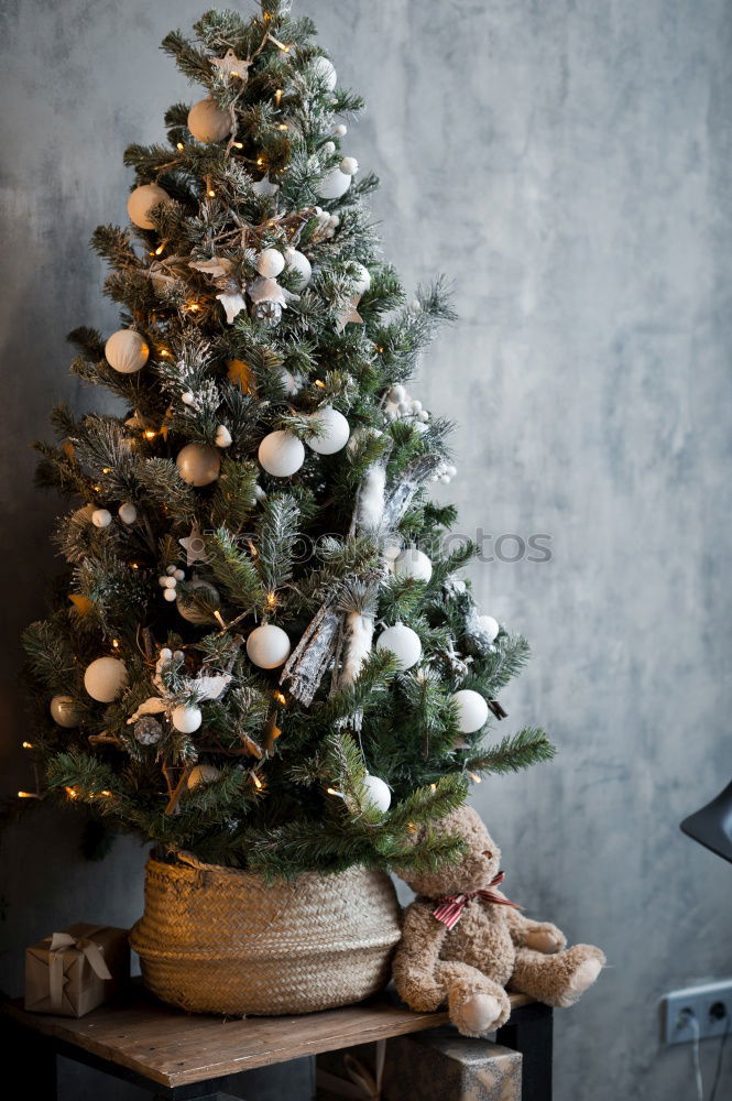 Rustic, beautiful Christmas decoration with twigs and a Christmas tree ball, on an old vintage table in winter during the Advent season. Christmas decorations with flower pot, tea light, glass vase, plants, cuttings on old stove, outside in the cold, icy garden.