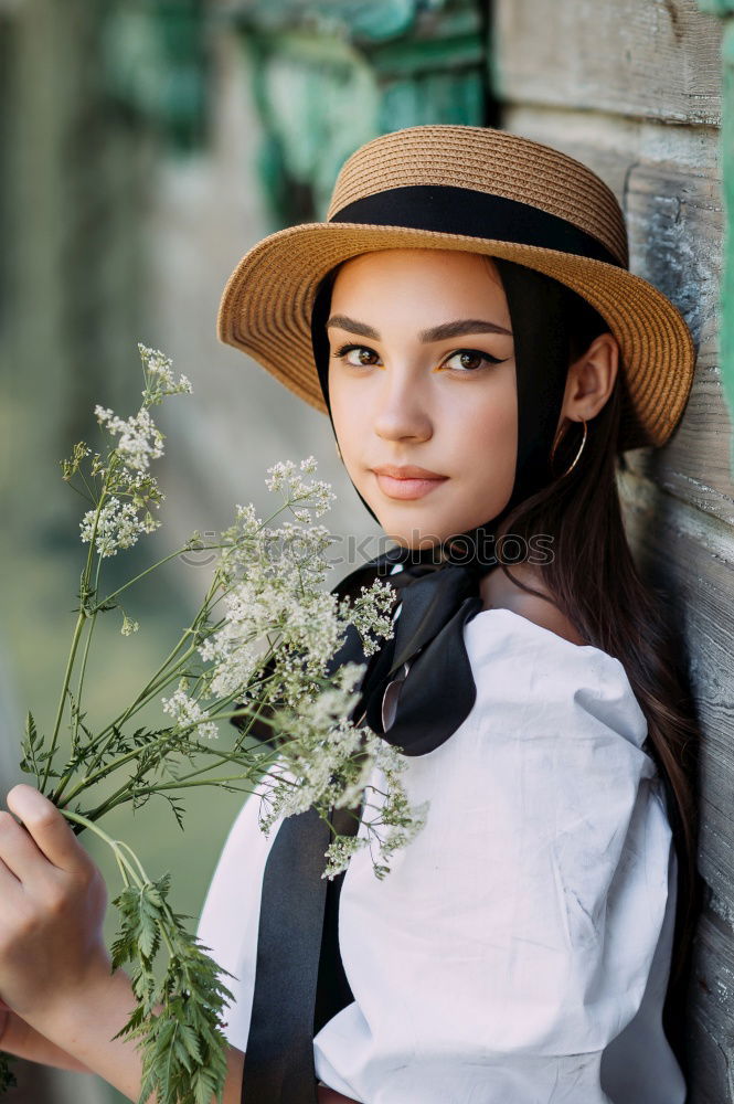 Similar – Pretty woman standing with white flowers