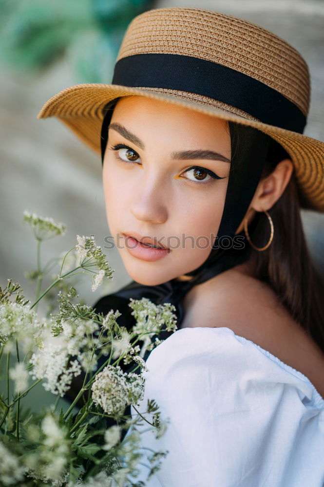 Similar – Pretty woman standing with white flowers