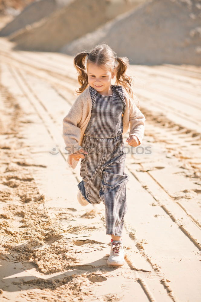 Back view of a little girl walking in nature