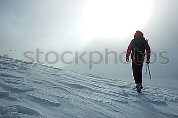 Skier in snowy landscape with hiking backpack