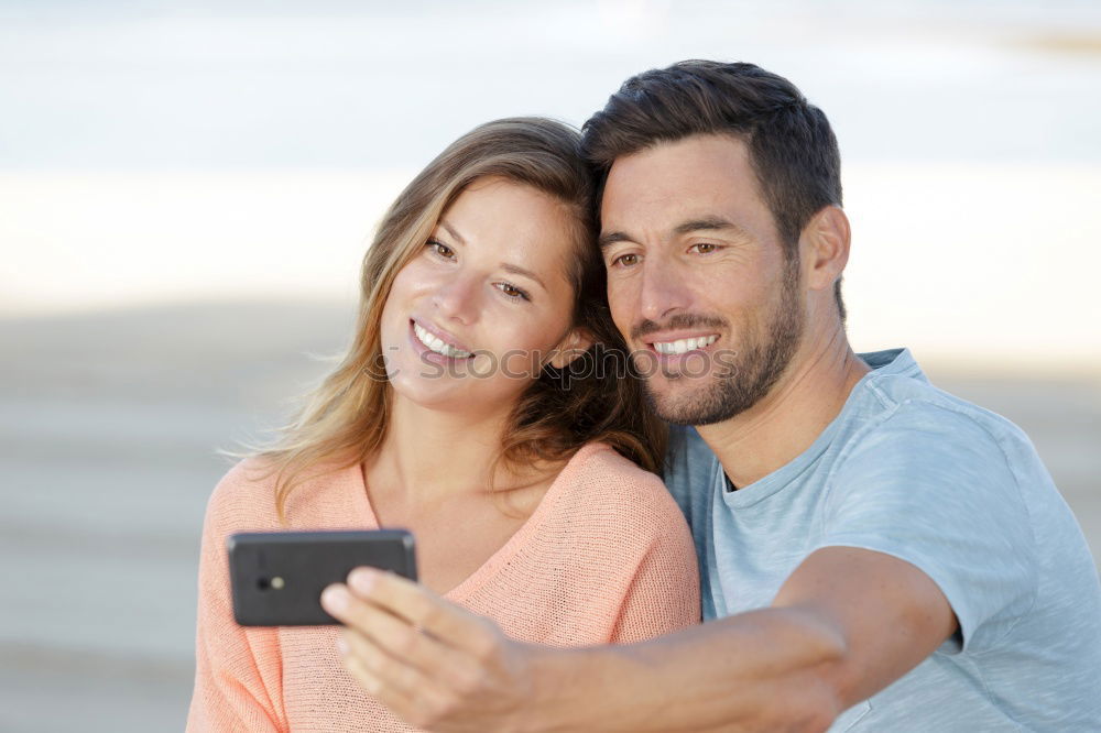 Similar – young cheerful couple taking a selfie