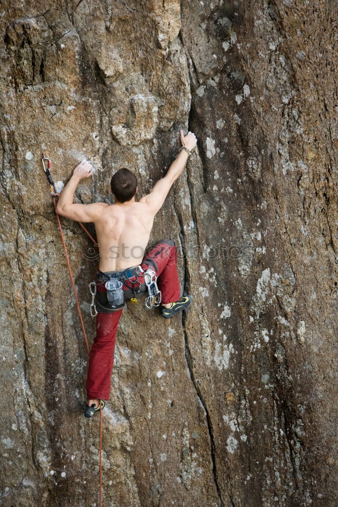 Similar – Female climber clinging to a cliff.