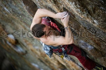 Similar – Female climber clinging to a cliff.