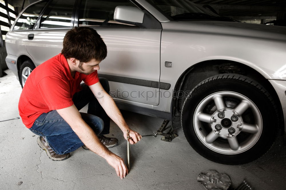 Similar – Professional Mechanic Repairing Car.