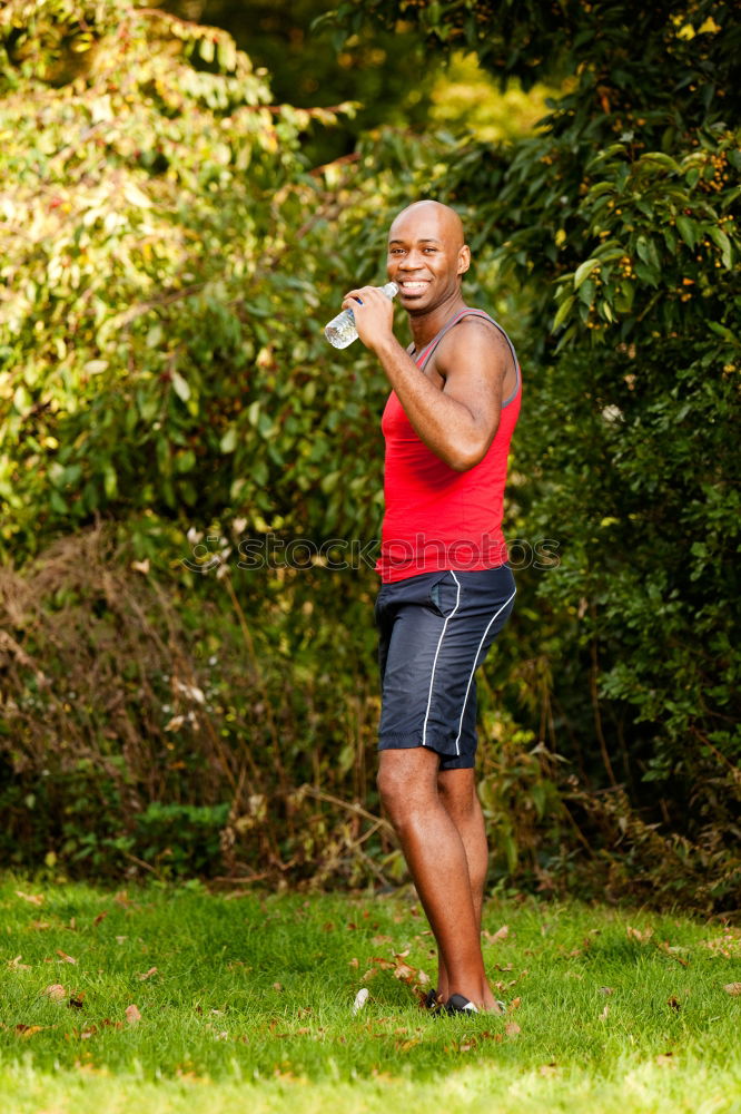 Fit shirtless young black man doing stretching