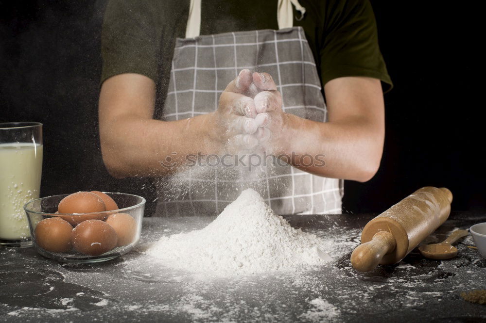 Similar – man sifts white wheat flour through a wooden sieve