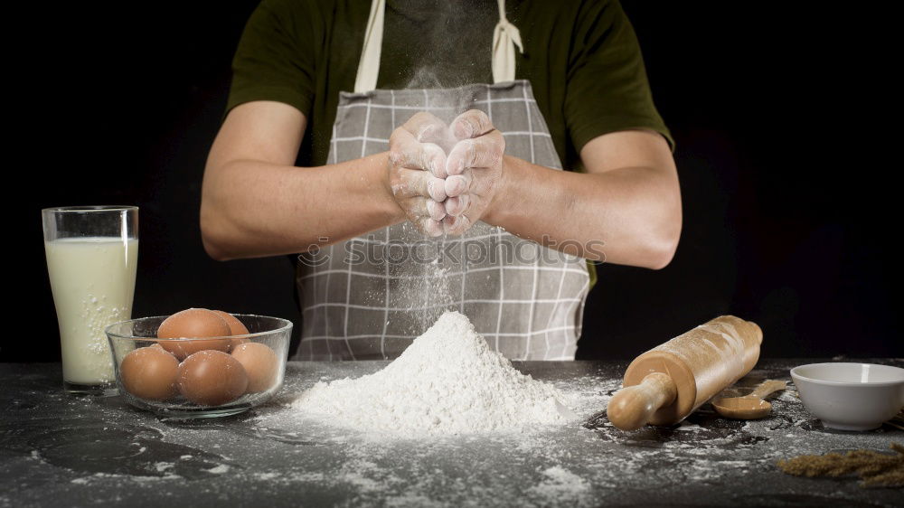 Similar – man sifts white wheat flour through a wooden sieve