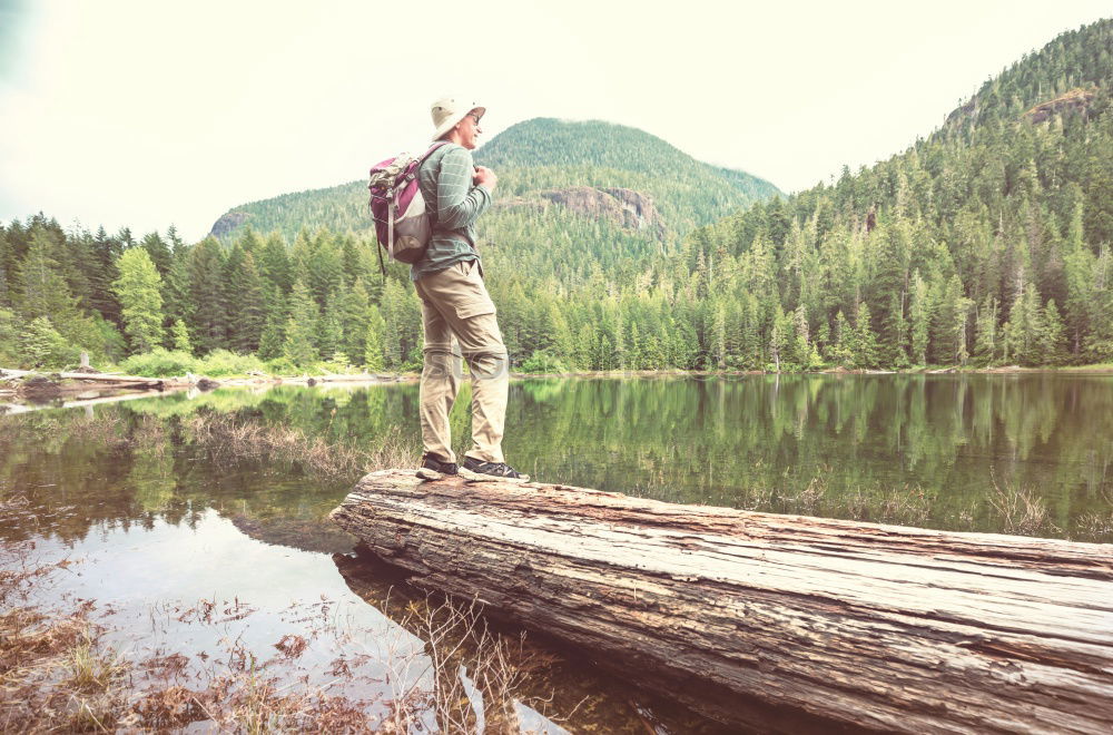 Similar – Image, Stock Photo Young tourist with backpack looks through a binoculars