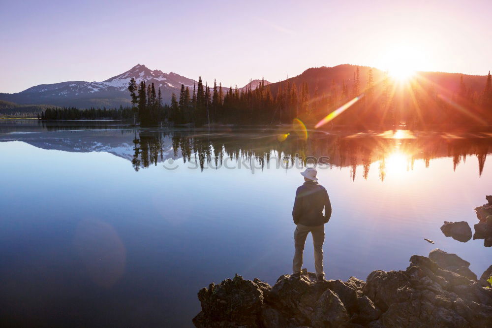 Similar – Mountain lake, woman standing