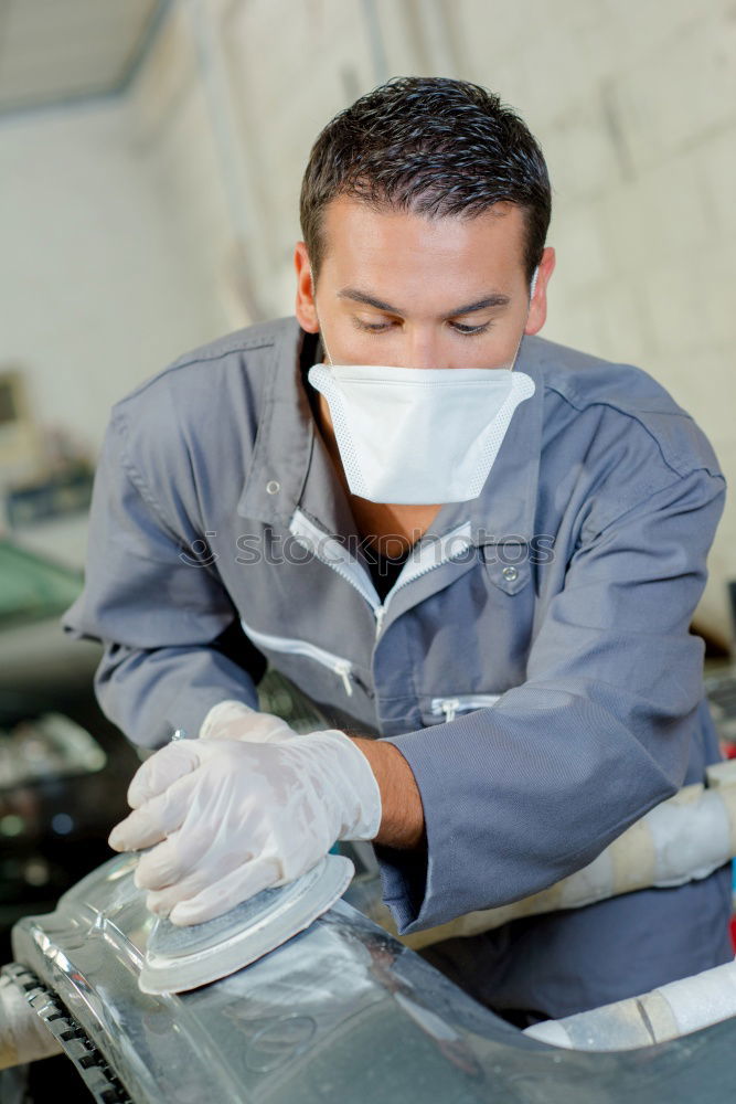 Similar – Man with a dust mask and goggles working on a circular saw