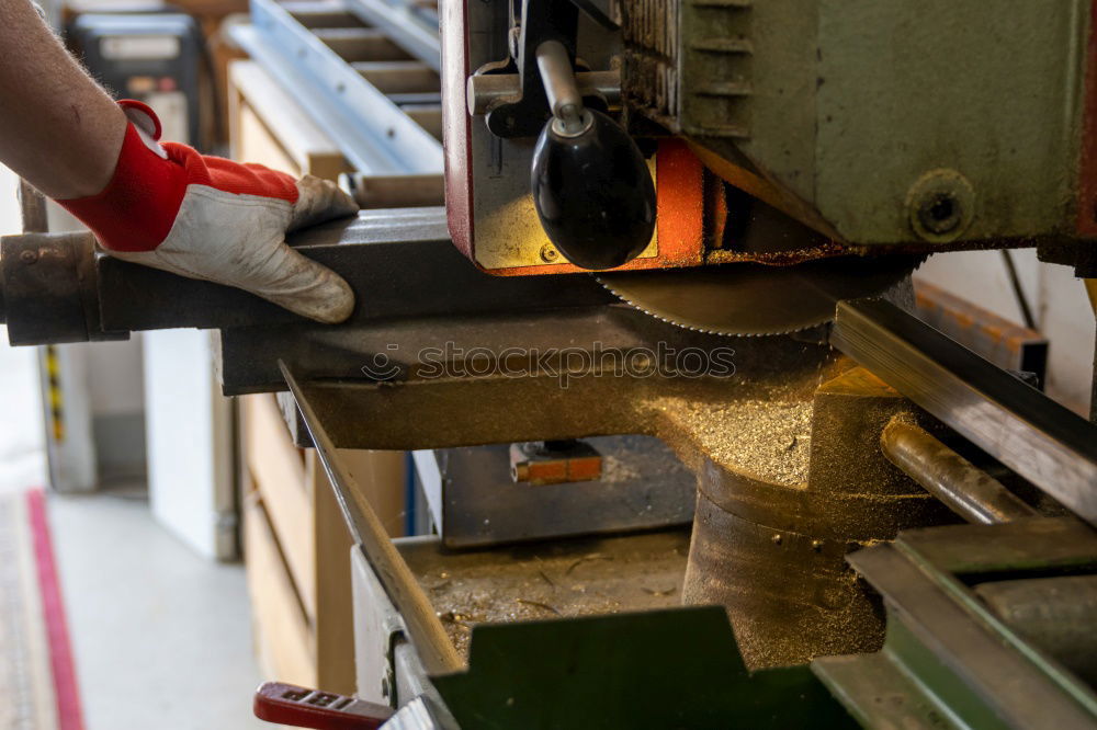 Similar – Unrecognizable worker cutting metal in garage