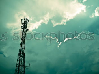 Similar – Telecommunication tower with cloudy sky background. Antenna on blue sky. Radio and satellite pole. Communication technology. Telecommunication industry. Mobile or telecom 5g network. Technology