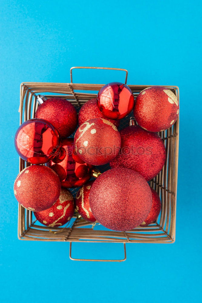 Red christmas balls and baubles in a basket