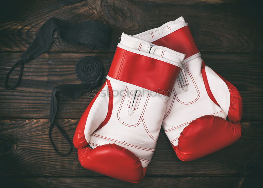 Man’s hand in red boxing gloves