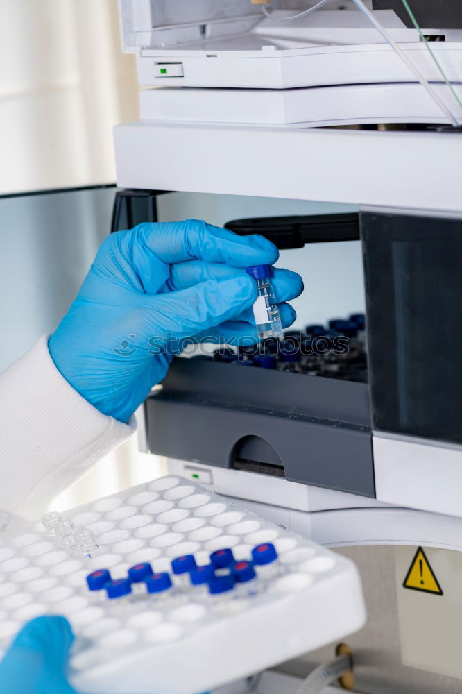 Similar – Worker putting liquid to test tube