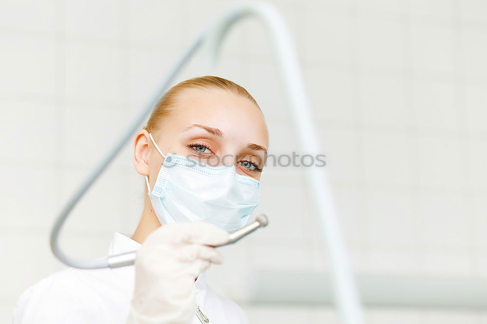 Similar – portrait of doctor woman wearing protective mask and gloves indoors. Using mobile phone. Corona virus concept