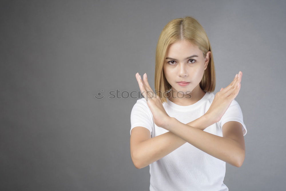 Similar – Girl with blonde hair posing in front of turquoise background