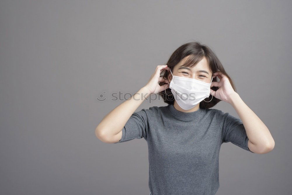 Similar – young woman wearing a mask and fogged glasses in autumn / winter (Corona / Covid-19)