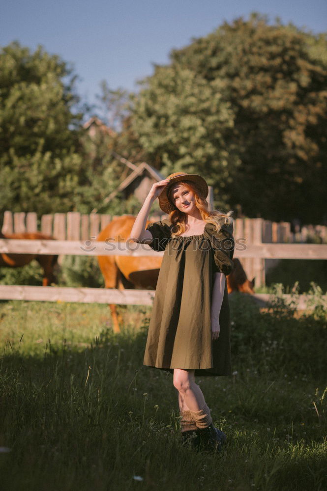 Young woman in a summer dress standing in an asparagus field