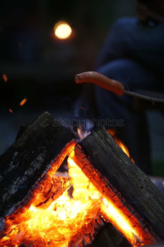 Similar – Man lights a fire in the fireplace