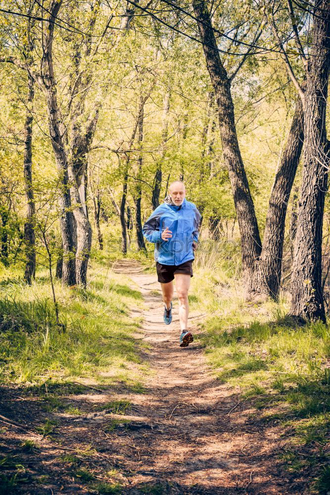 Senior Man Running in the Forest