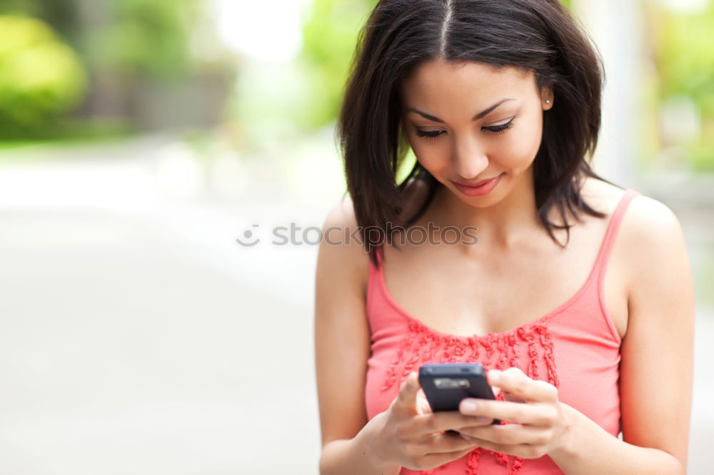 Similar – Young woman texting with a smartphone outdoors