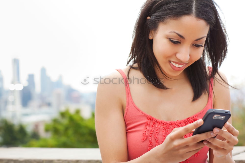 Similar – Young woman texting with a smartphone outdoors