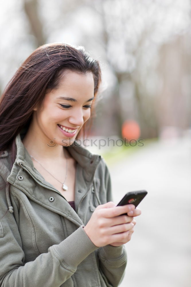 Young woman texting with a smartphone outdoors