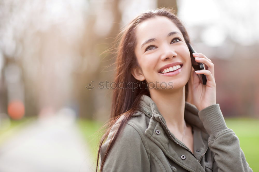 Similar – Smiling Woman in Autumn Fashion Talking on Phone