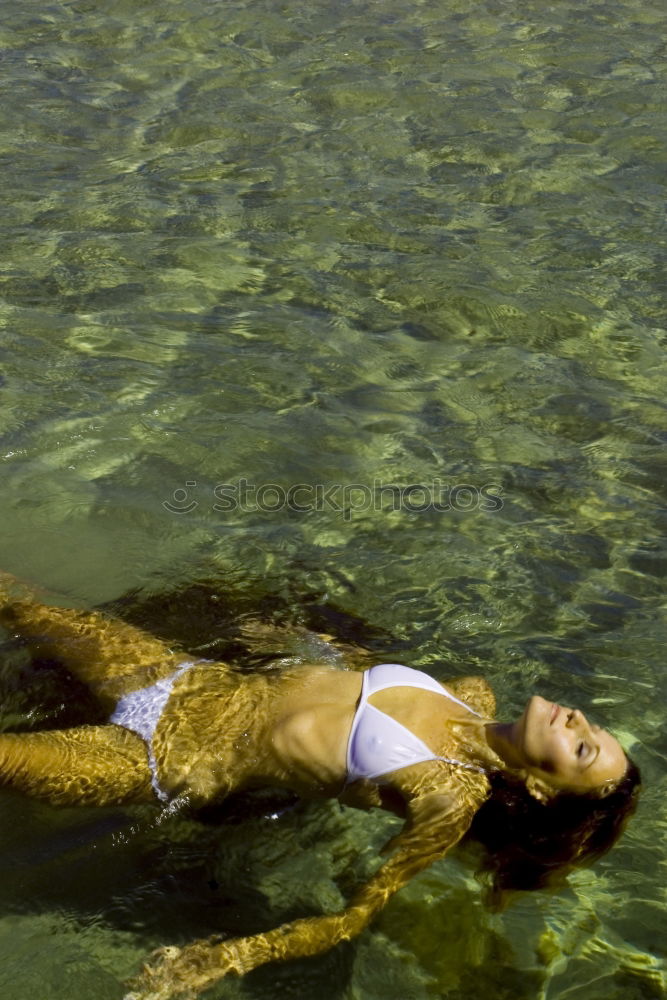 Similar – Breast swimming young woman with a red bikini in a swimming pond