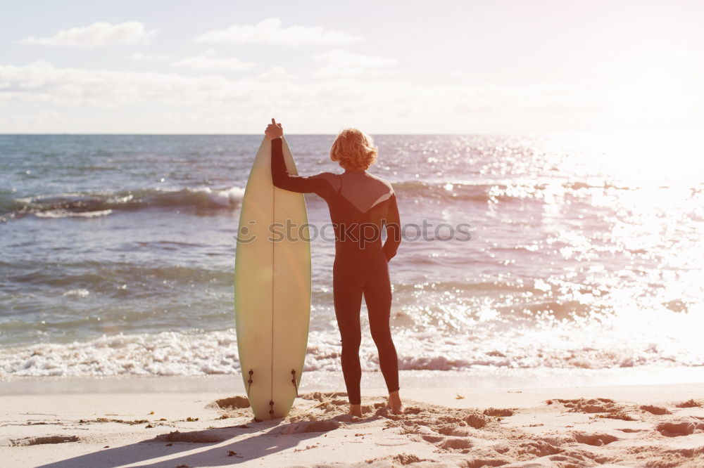 Similar – Man standing with skateboard at shore