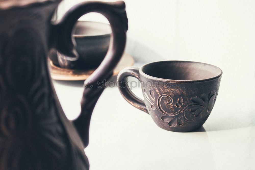 Similar – A painted ceramic milk jug next to an empty white cup