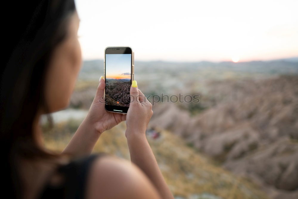 Similar – Image, Stock Photo Young woman is holding smartphone in her hands at the beach