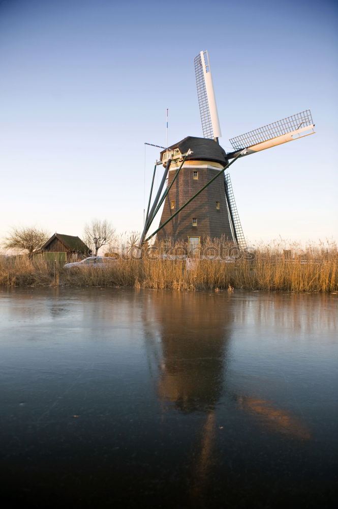 Similar – charming windmill by river at sunrise