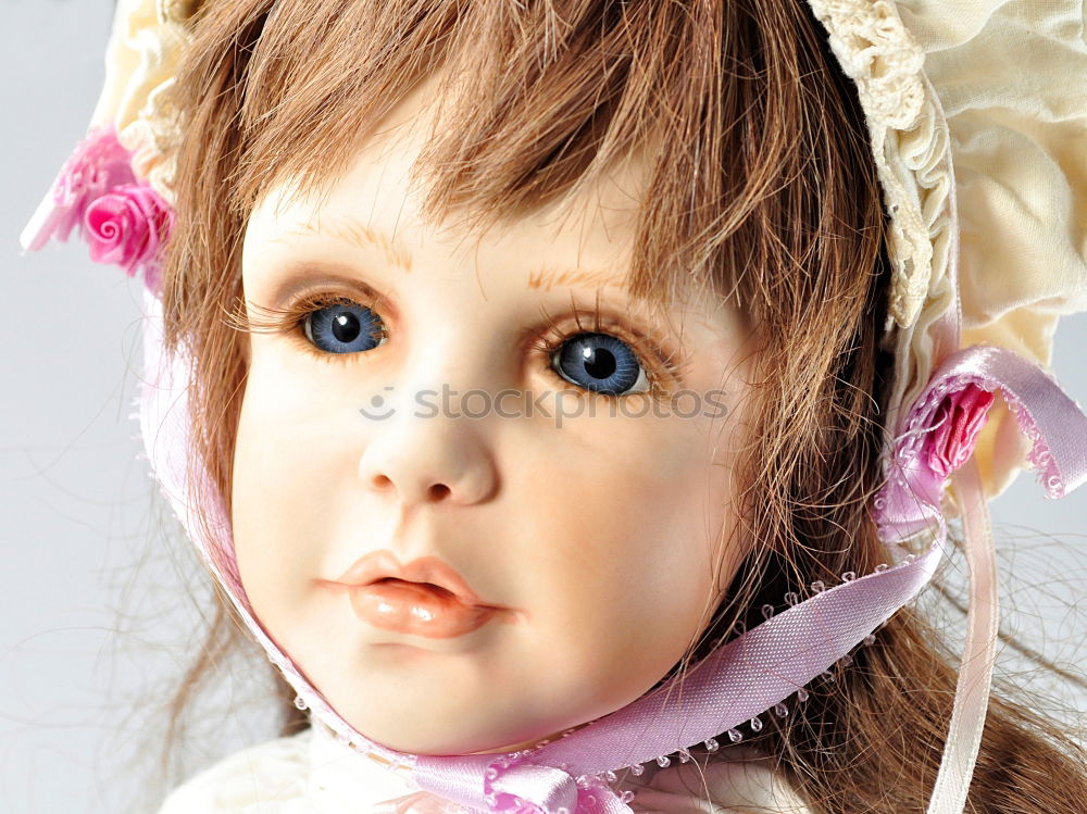 Similar – old doll with pigtails and a stare