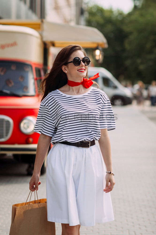 Similar – Image, Stock Photo Back view rear view of a woman holding shopping bags while wearing cool style cloths. Jeans and a top. Shopping street. Changing and buying gifts concept.