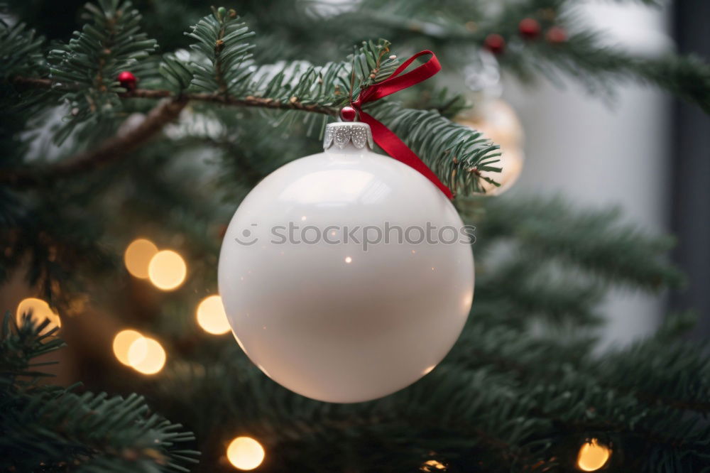 Similar – a matt golden Christmas bauble hangs from the branch of a Christmas tree