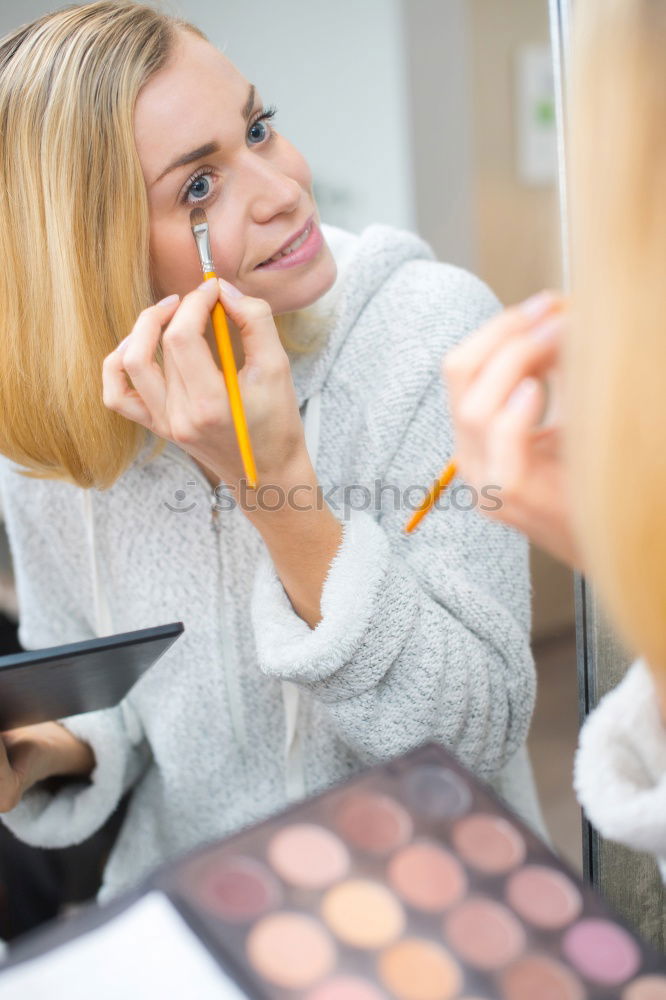 Similar – Young gender fluid person applying makeup at home