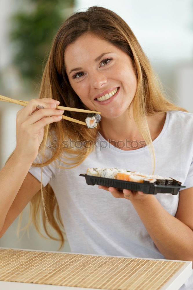 Similar – Crop woman eating sushi