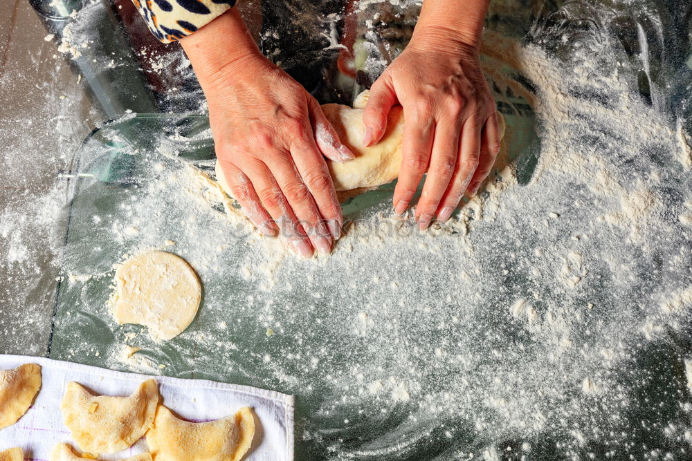 Similar – woman in bakery preparing sweets adding egg